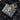 Close-up of a "Century Penthouse" leather brand patch on black textured pants with rhinestone details.
