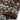 Close-up of the khaki Pixel Fade Polo sleeve, featuring a multi-toned pixelated knit and a solid brown ribbed cuff.